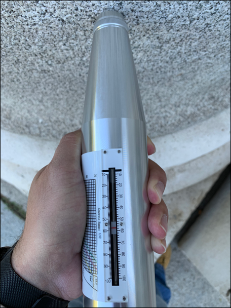 Measurement of the mechanical resistance by means of the Schmidt hammer, in a column at the entrance of the Prado Museum in Madrid, Spain (photo by the author).