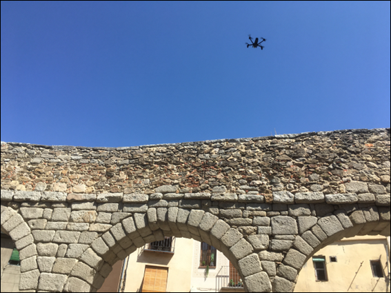 Quadrotor drone flying over the Roman Aqueduct of Segovia, for inspection (photo by the author).